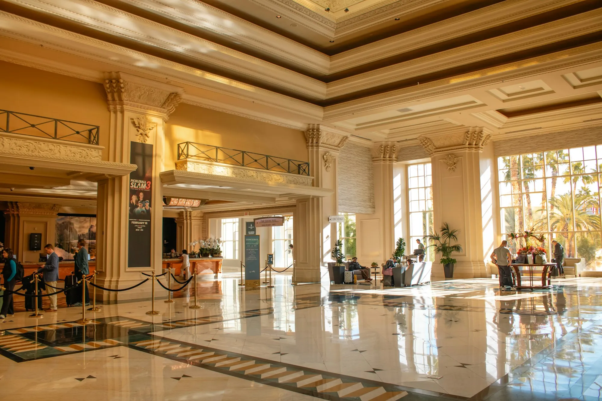 A sunlit, marble hotel lobby
